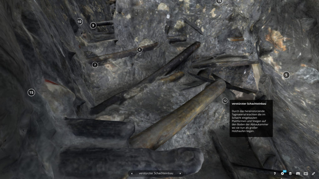 Innerhalb des 3D-Modells der Mine.  Quer zum Tunnel liegen dem Holzeile des eingestürzten Schachtes.